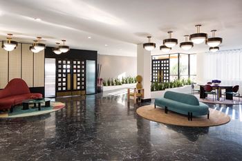 the lobby or reception area of a hotel with couches and chairs at The Flat, Los Angeles, CA, 90017